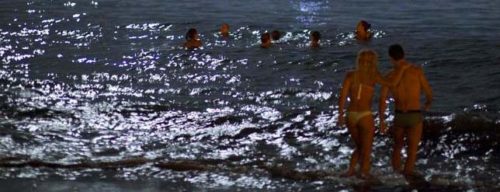 Beach at midnight during Midsummer's Eve or St. John's bonfires at night